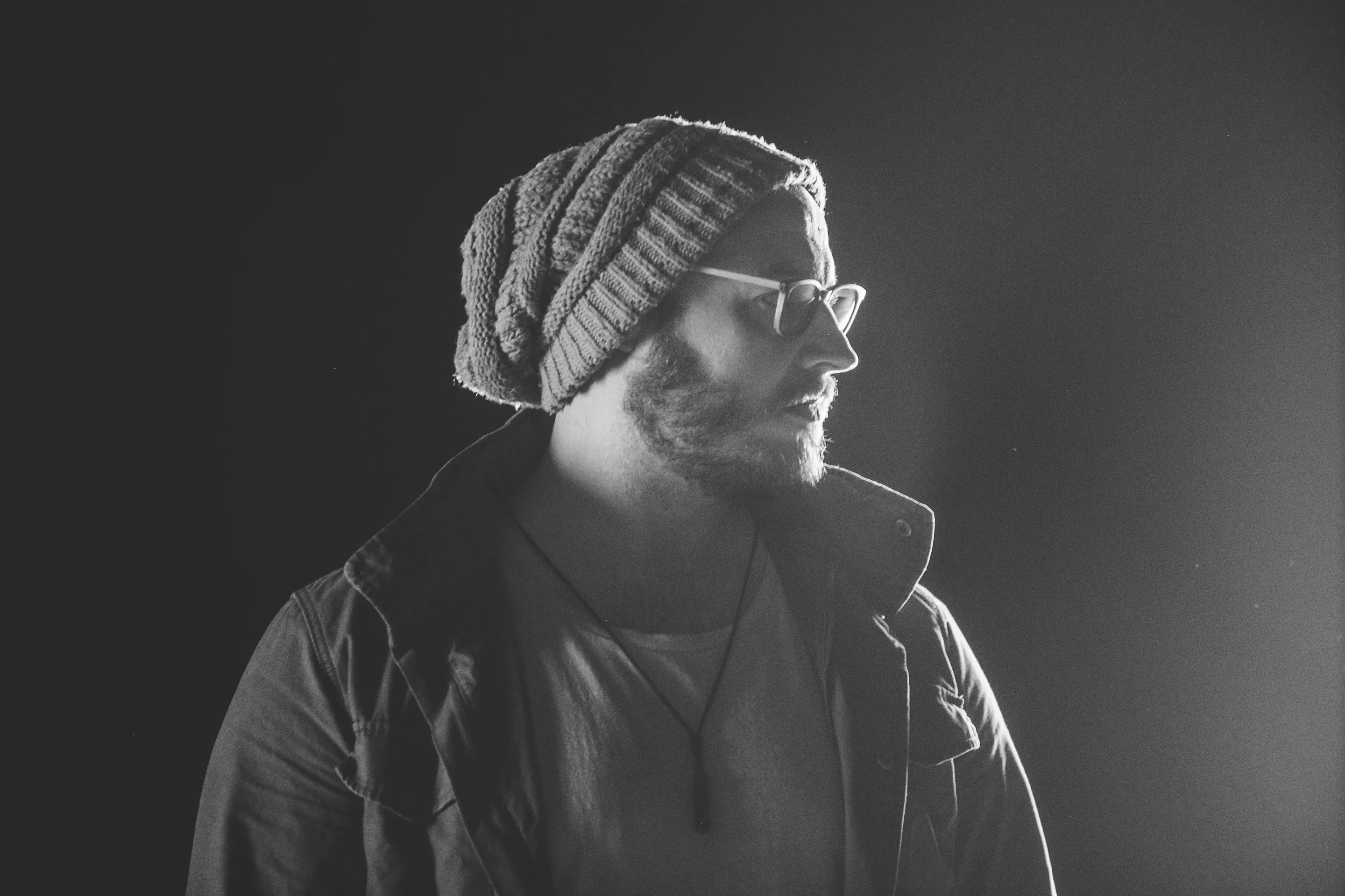 Jonathan Heston, in profile, lit against a dark studio